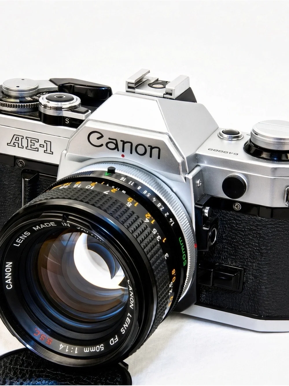 Canon silver and black AE-1 with 50mm f/1.4 and 70-210mm lenses